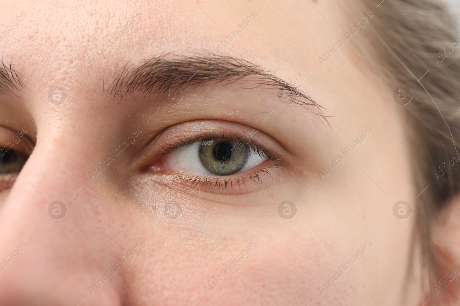 Photo of Closeup view of young woman with beautiful eyes