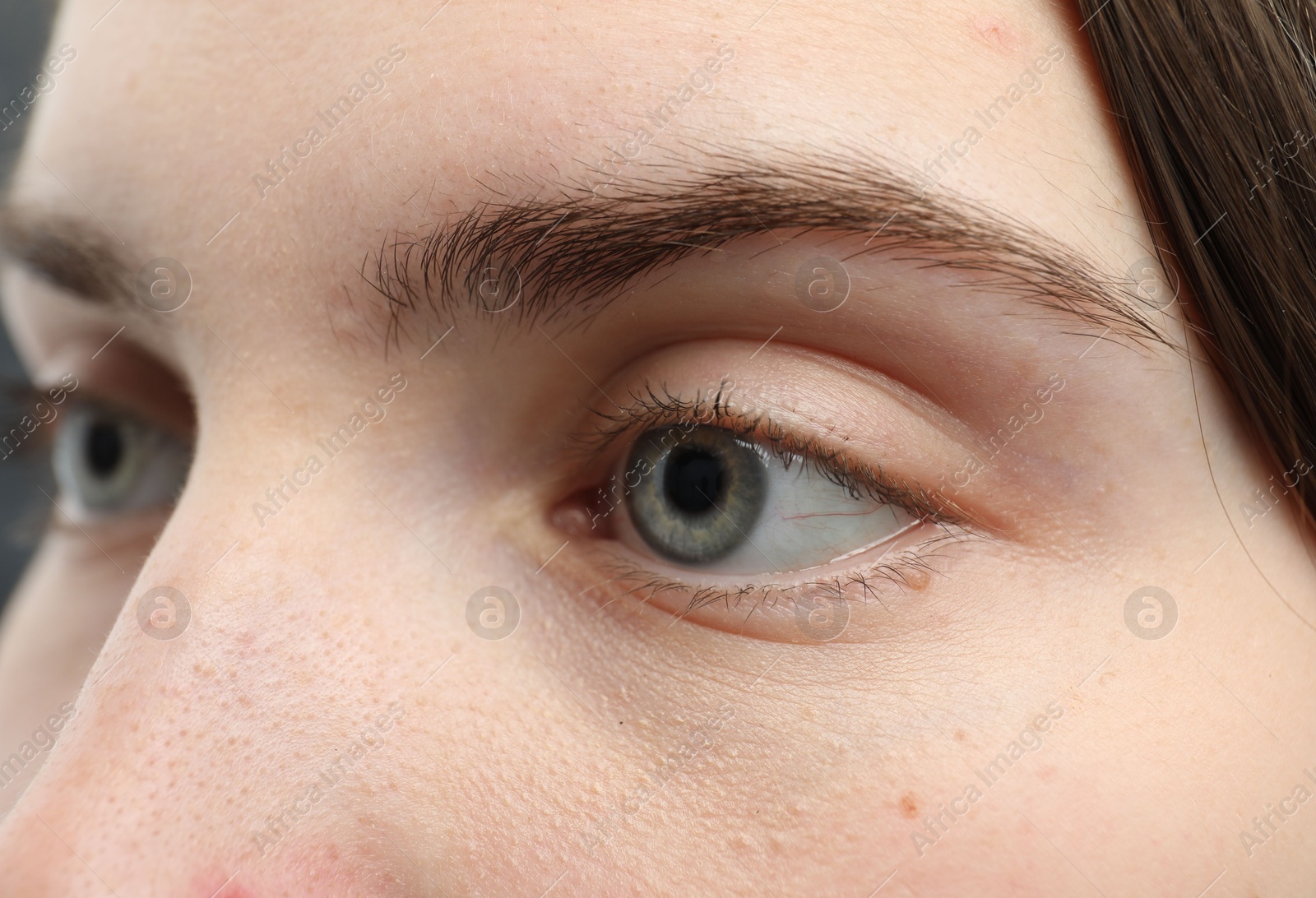 Photo of Closeup view of young woman with beautiful blue eyes