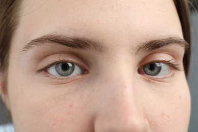 Photo of Closeup view of young woman with beautiful blue eyes