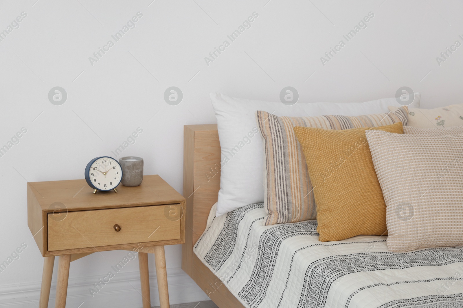 Photo of Bed with beautiful cushions in room. Interior design