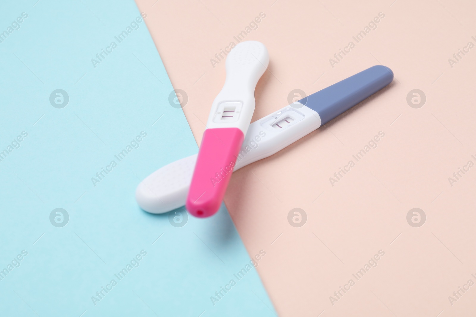 Photo of Two pregnancy tests on color background, closeup