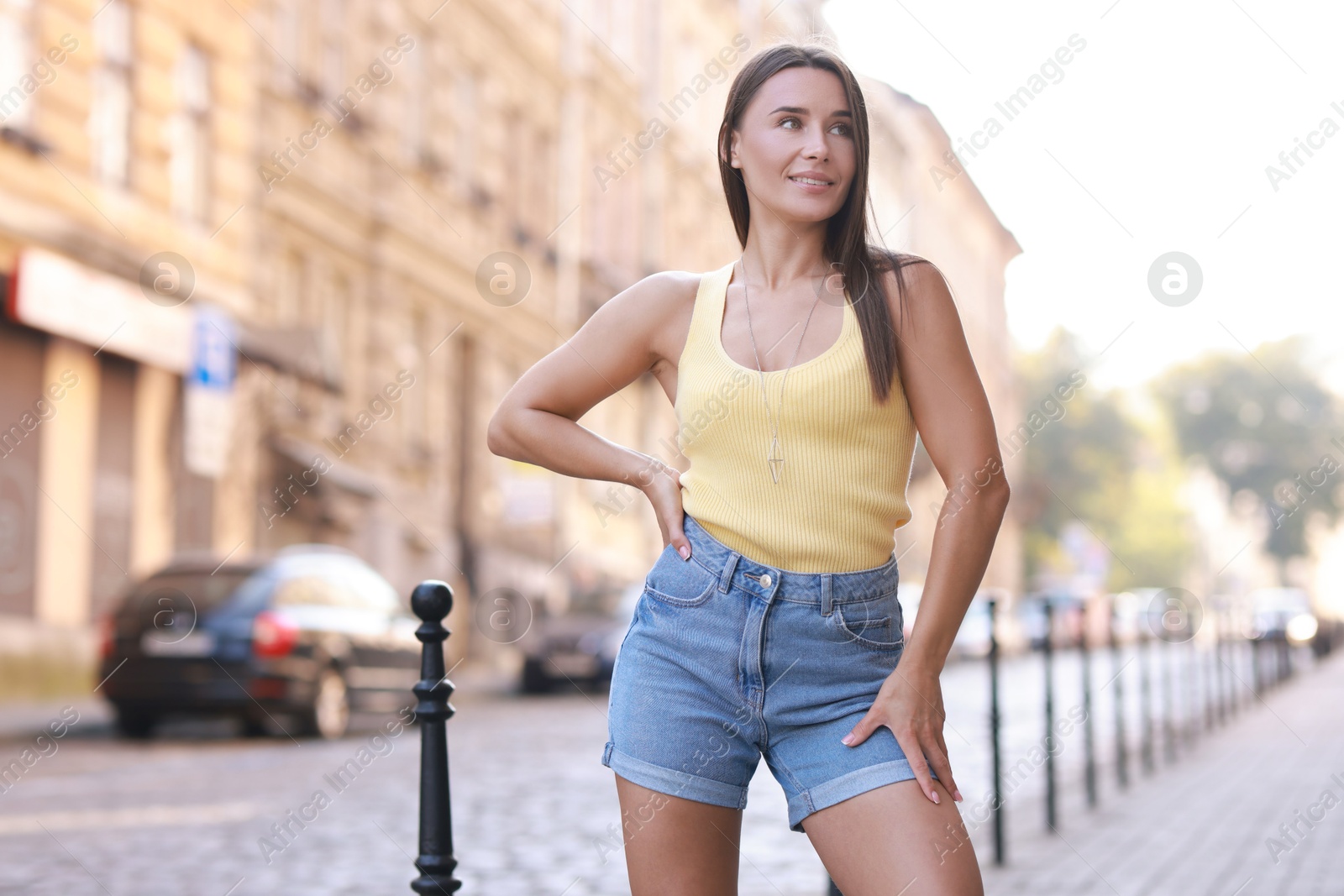 Photo of Beautiful woman wearing stylish denim shorts outdoors