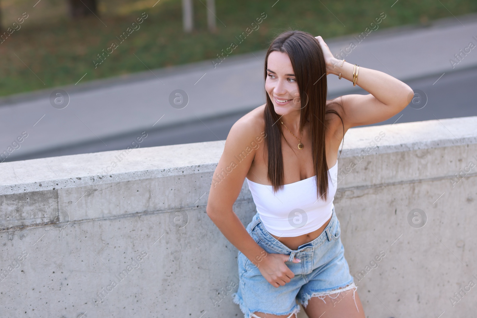 Photo of Beautiful woman wearing stylish denim shorts outdoors