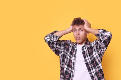 Stressful young student before exam on yellow background, space for text