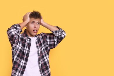 Photo of Stressful young student before exam on yellow background, space for text