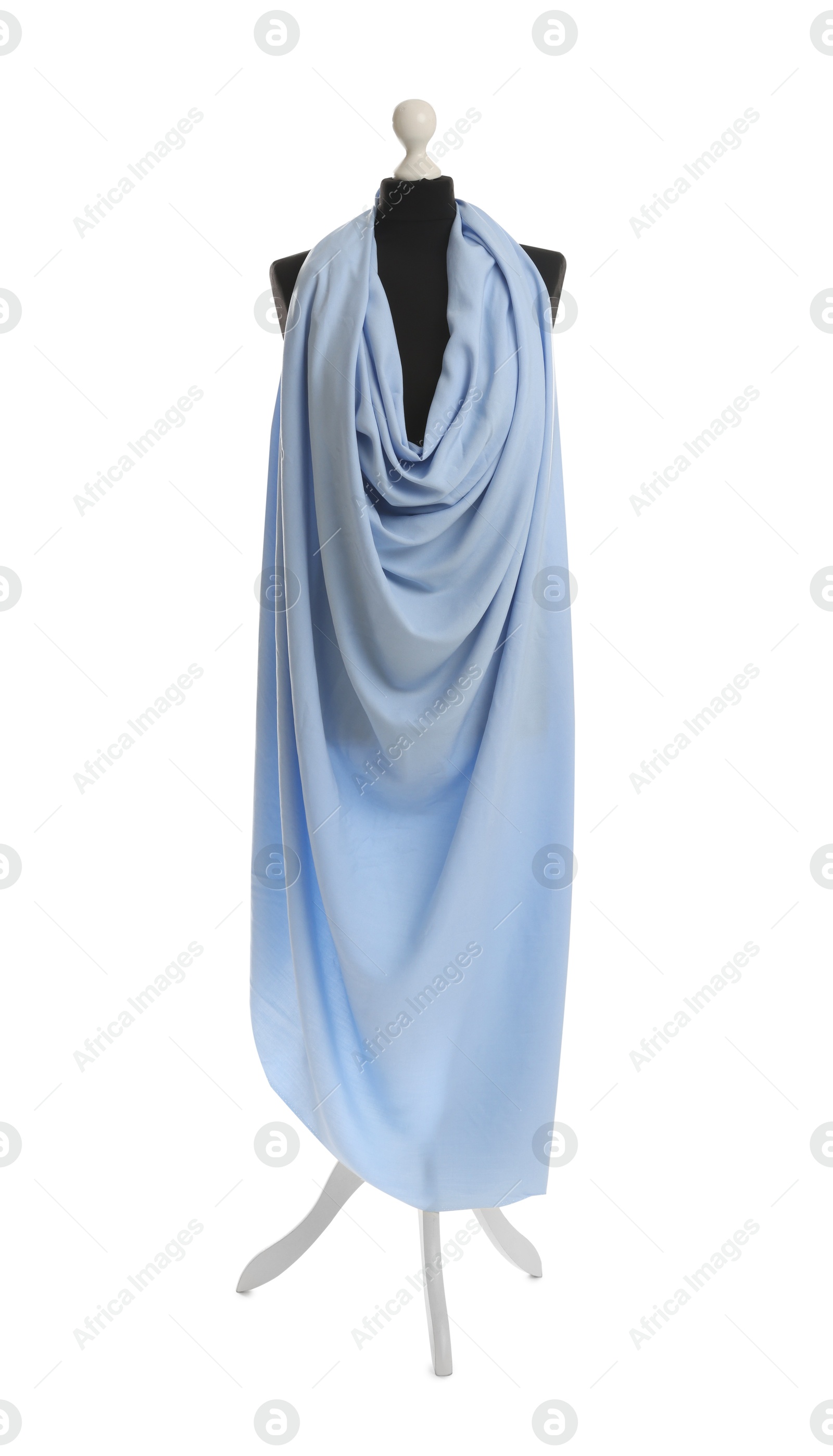 Photo of Draping light blue fabric on female mannequin against white background