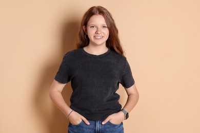 Photo of Portrait of smiling teenage girl on beige background