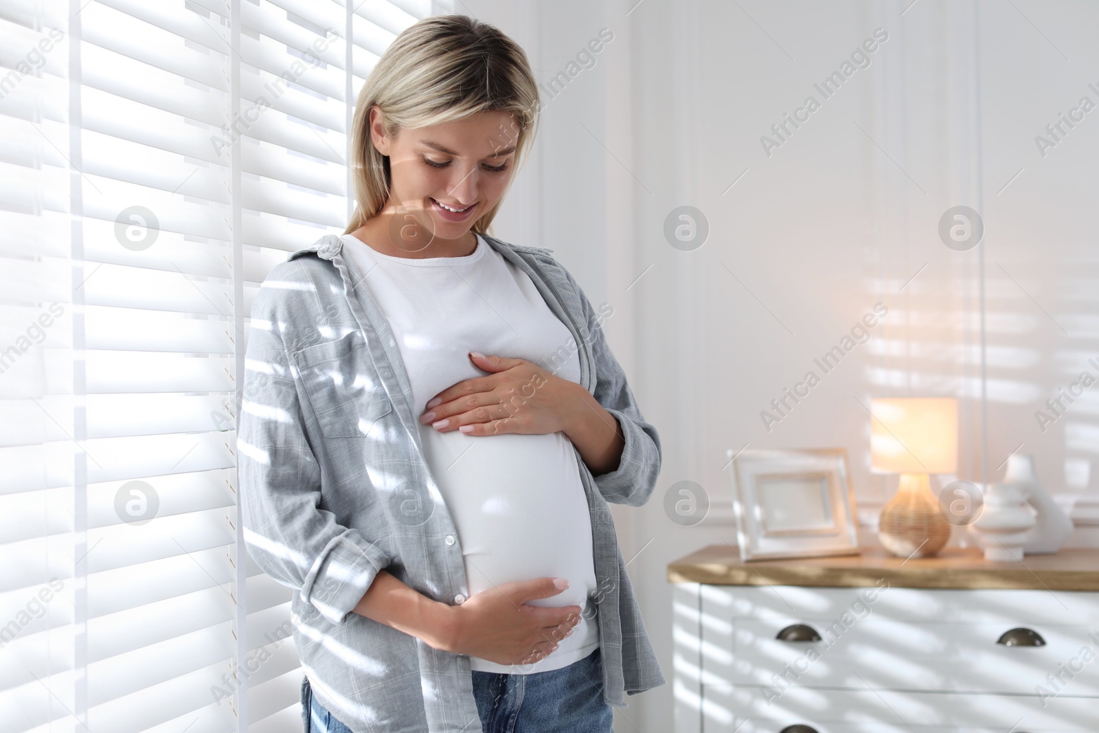 Photo of Portrait of beautiful pregnant woman at home