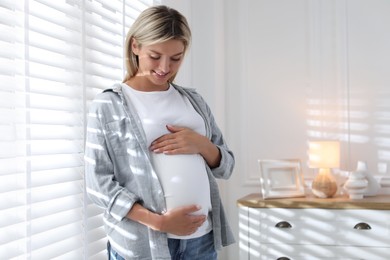 Portrait of beautiful pregnant woman at home