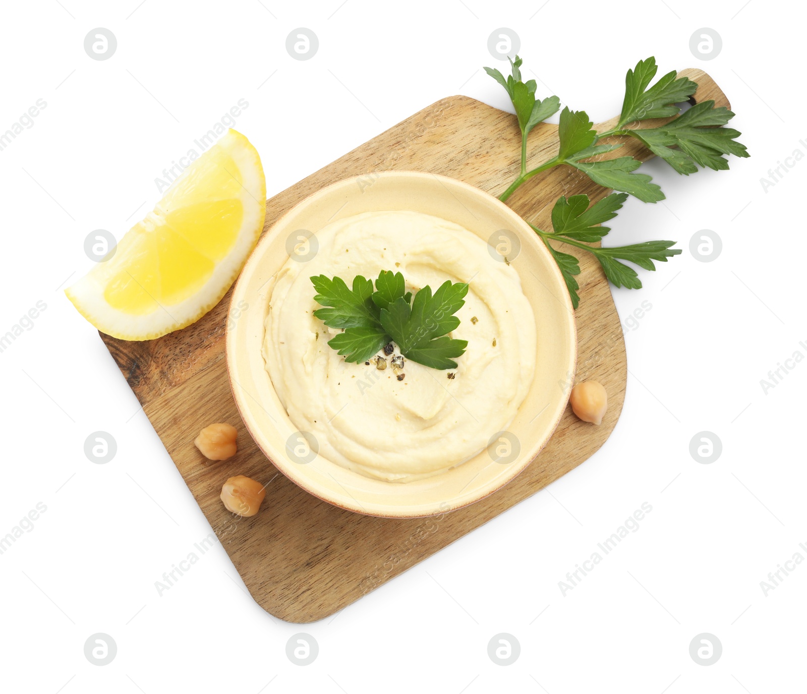 Photo of Delicious hummus with chickpeas, parsley and lemon isolated on white, top view