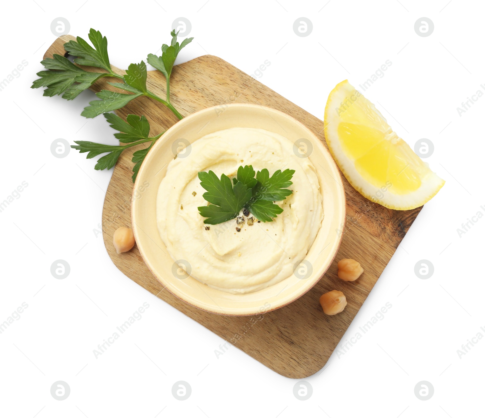 Photo of Delicious hummus with chickpeas, parsley and lemon isolated on white, top view