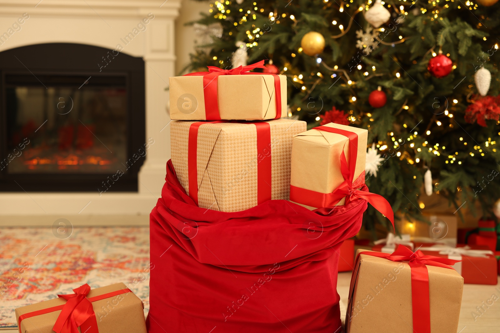 Photo of Santa bag full of Christmas presents at home, closeup