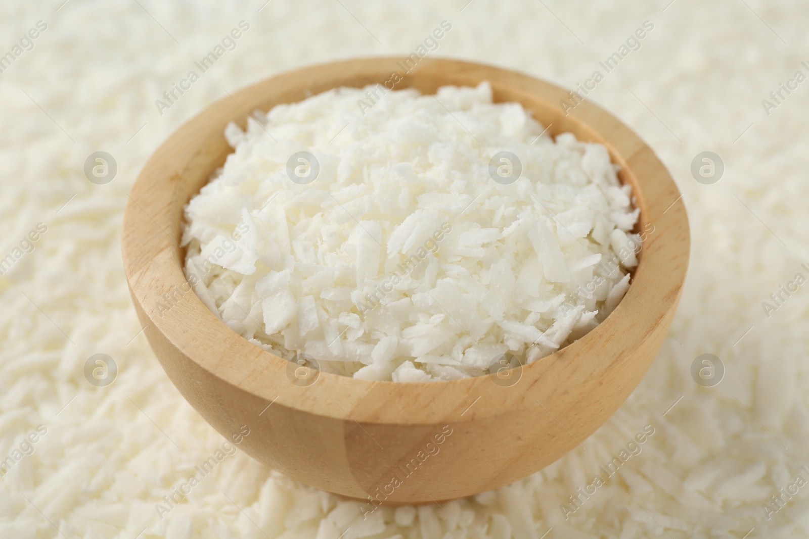 Photo of White soy wax flakes and bowl, closeup