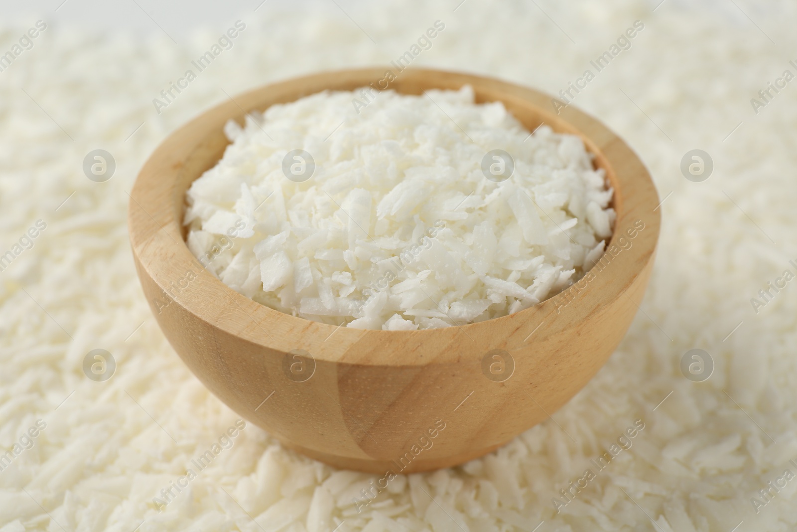 Photo of White soy wax flakes and bowl, closeup