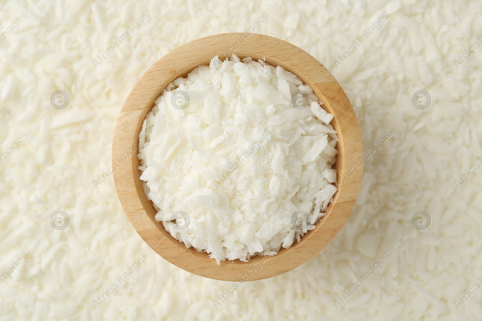 Photo of White soy wax flakes and bowl, top view