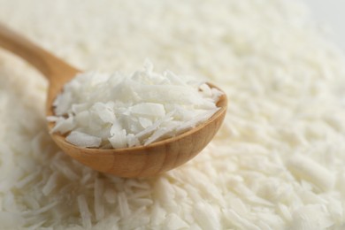 Photo of White soy wax flakes and spoon, closeup