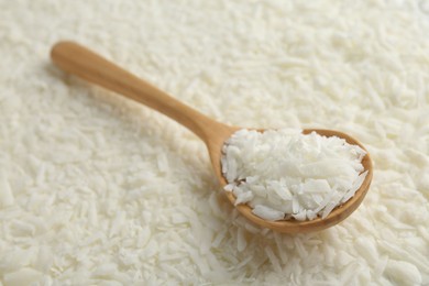 Photo of White soy wax flakes and spoon, closeup