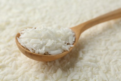 Photo of White soy wax flakes and spoon, closeup