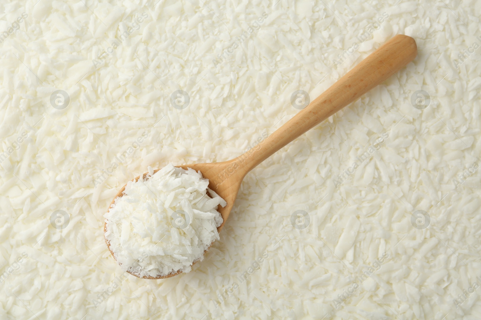 Photo of White soy wax flakes and spoon, top view