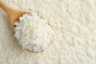 Photo of White soy wax flakes and spoon, closeup