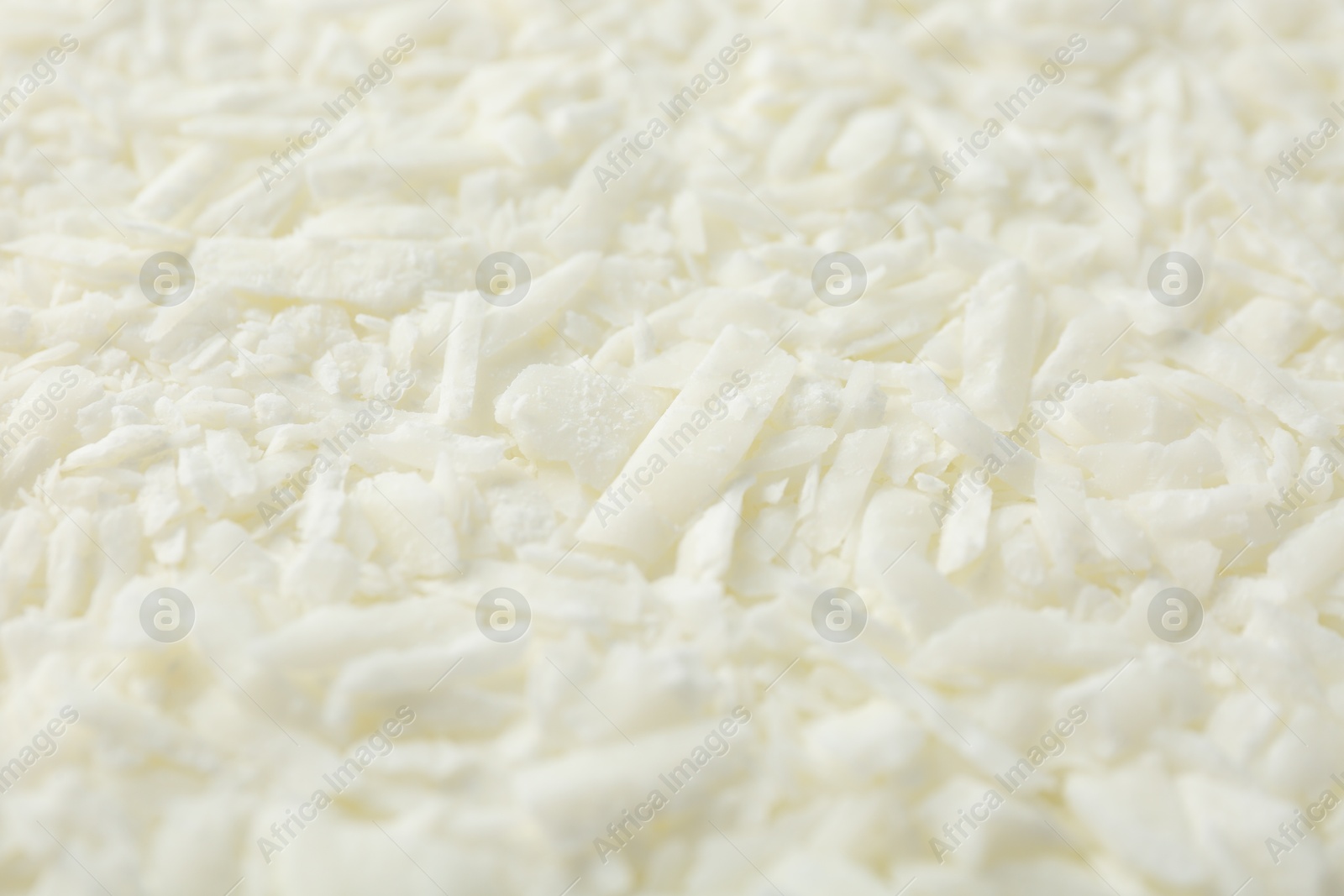 Photo of White soy wax flakes as background, closeup