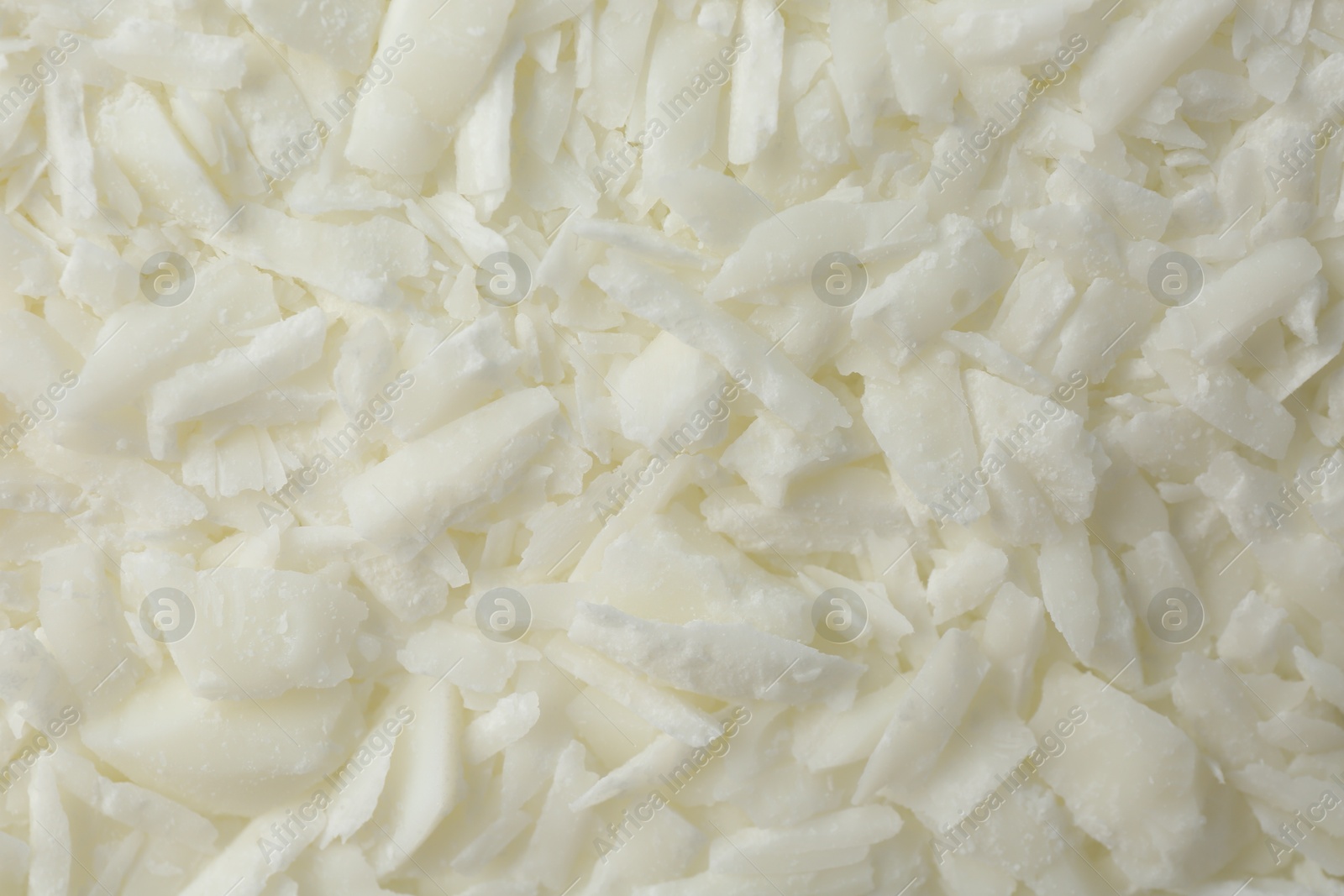 Photo of White soy wax flakes as background, closeup