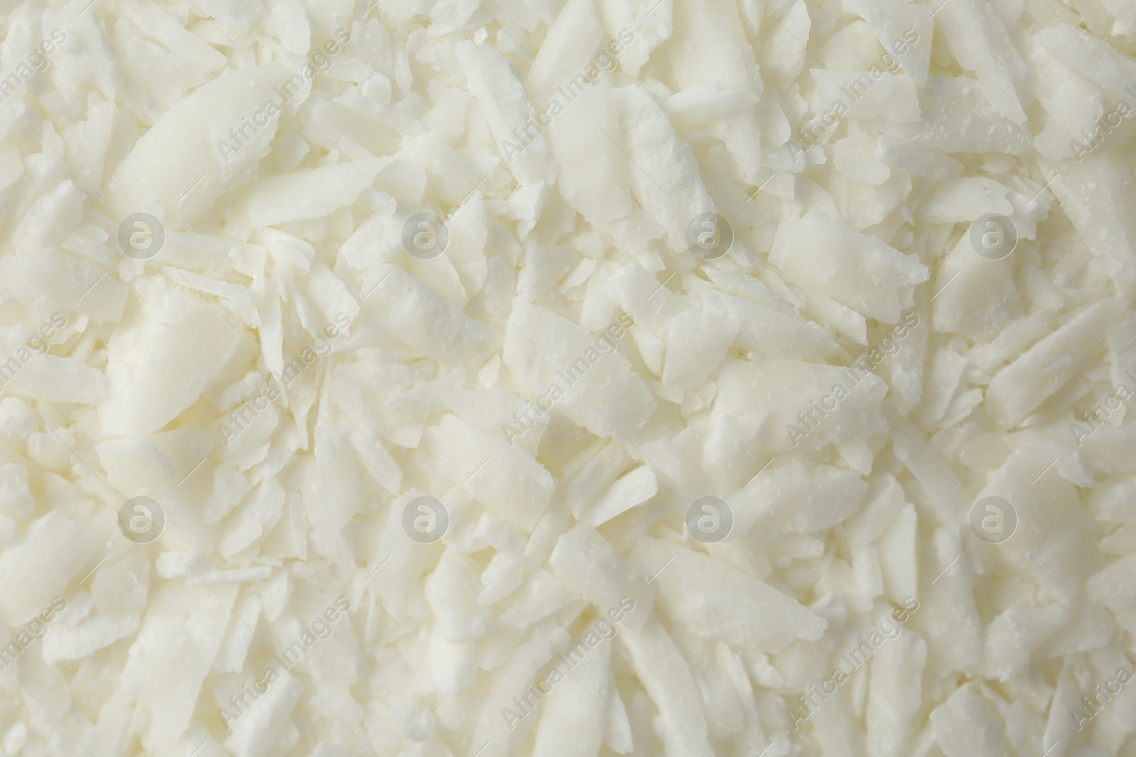 Photo of White soy wax flakes as background, closeup