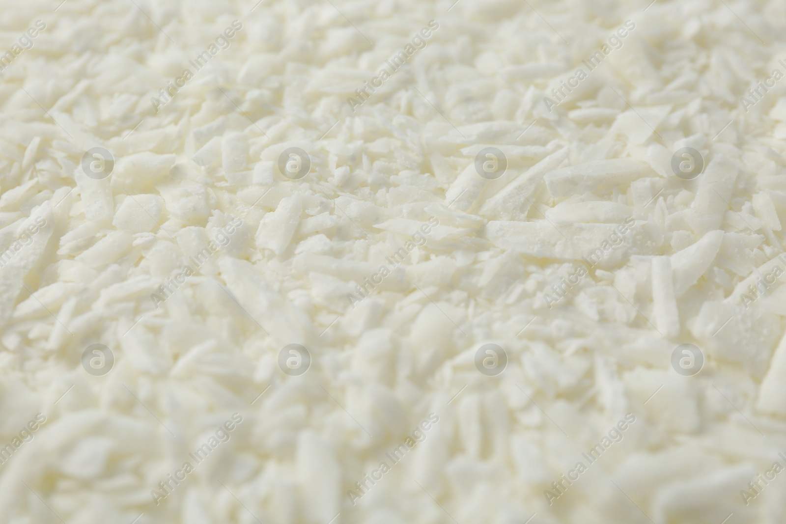 Photo of White soy wax flakes as background, closeup