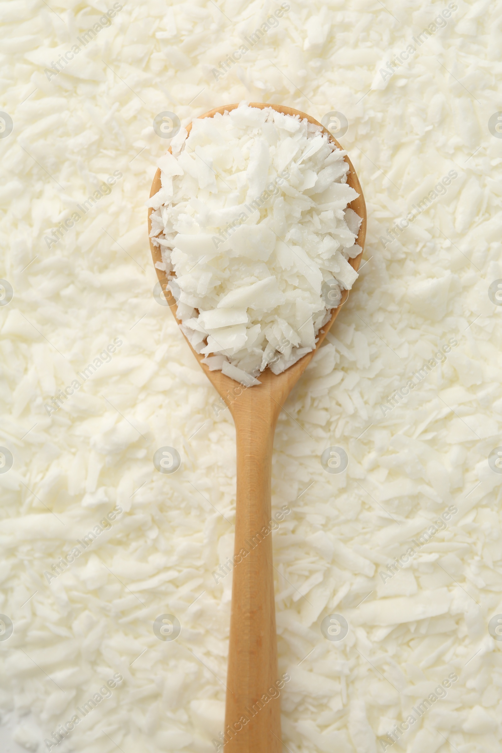 Photo of White soy wax flakes and spoon, top view