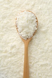 Photo of White soy wax flakes and spoon, top view