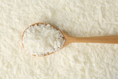 Photo of White soy wax flakes and spoon, top view