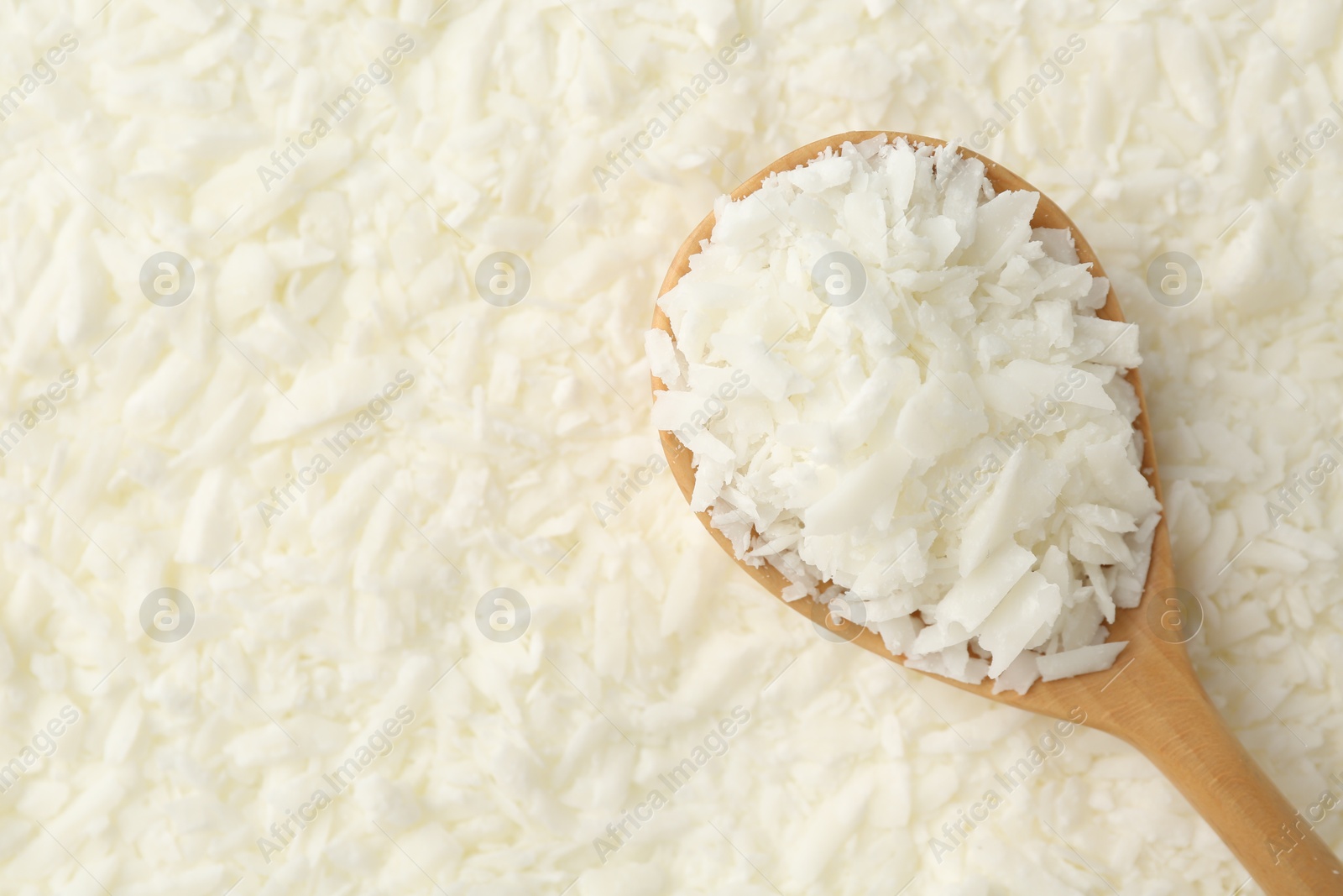 Photo of White soy wax flakes and spoon, top view