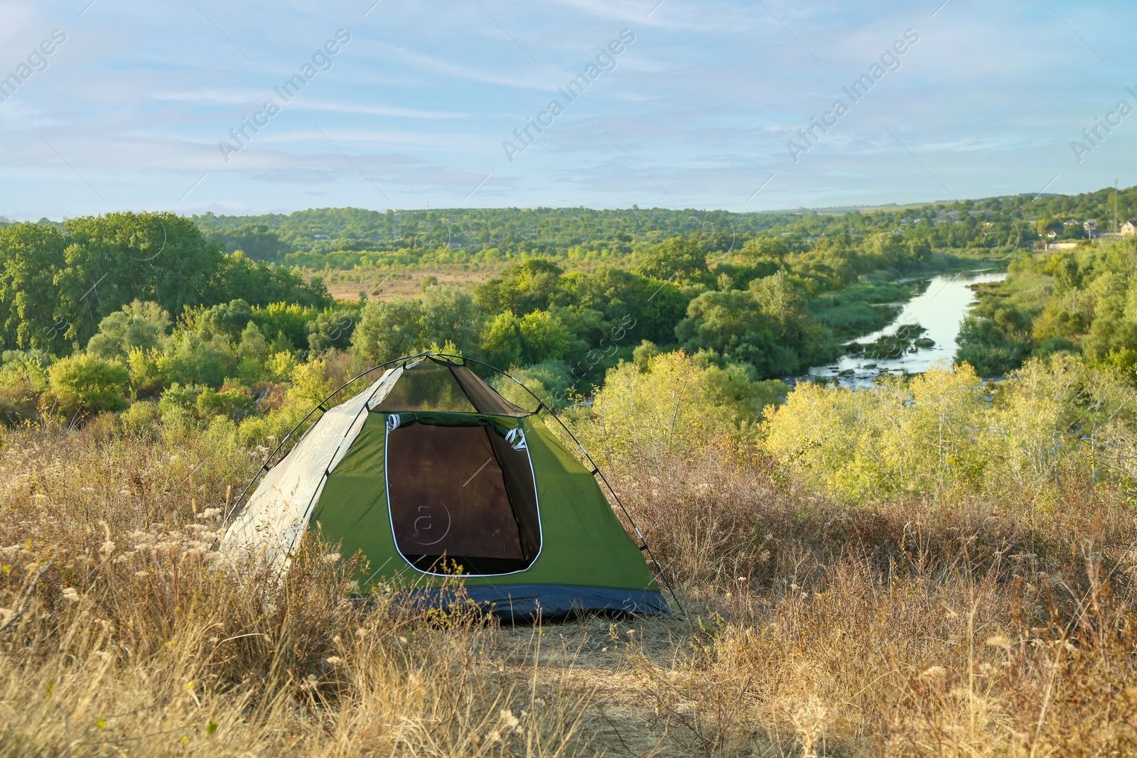 Photo of One camping tent among plants outdoors on sunny day. Space for text