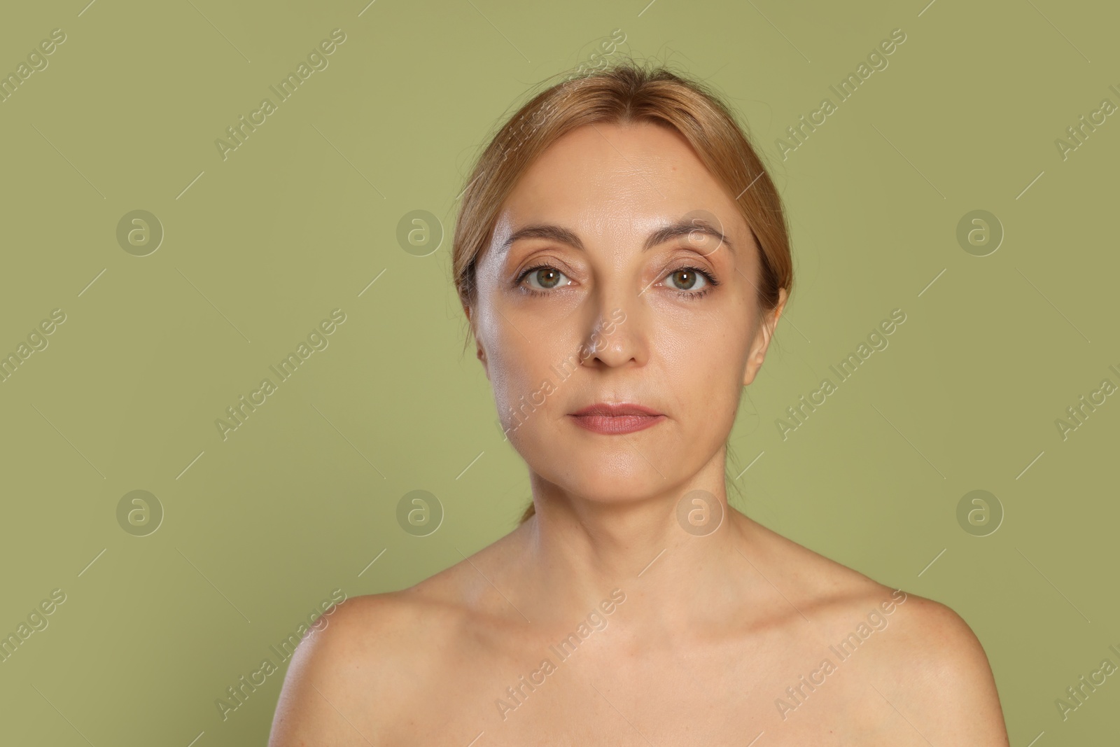 Photo of Portrait of beautiful woman with healthy skin on green background