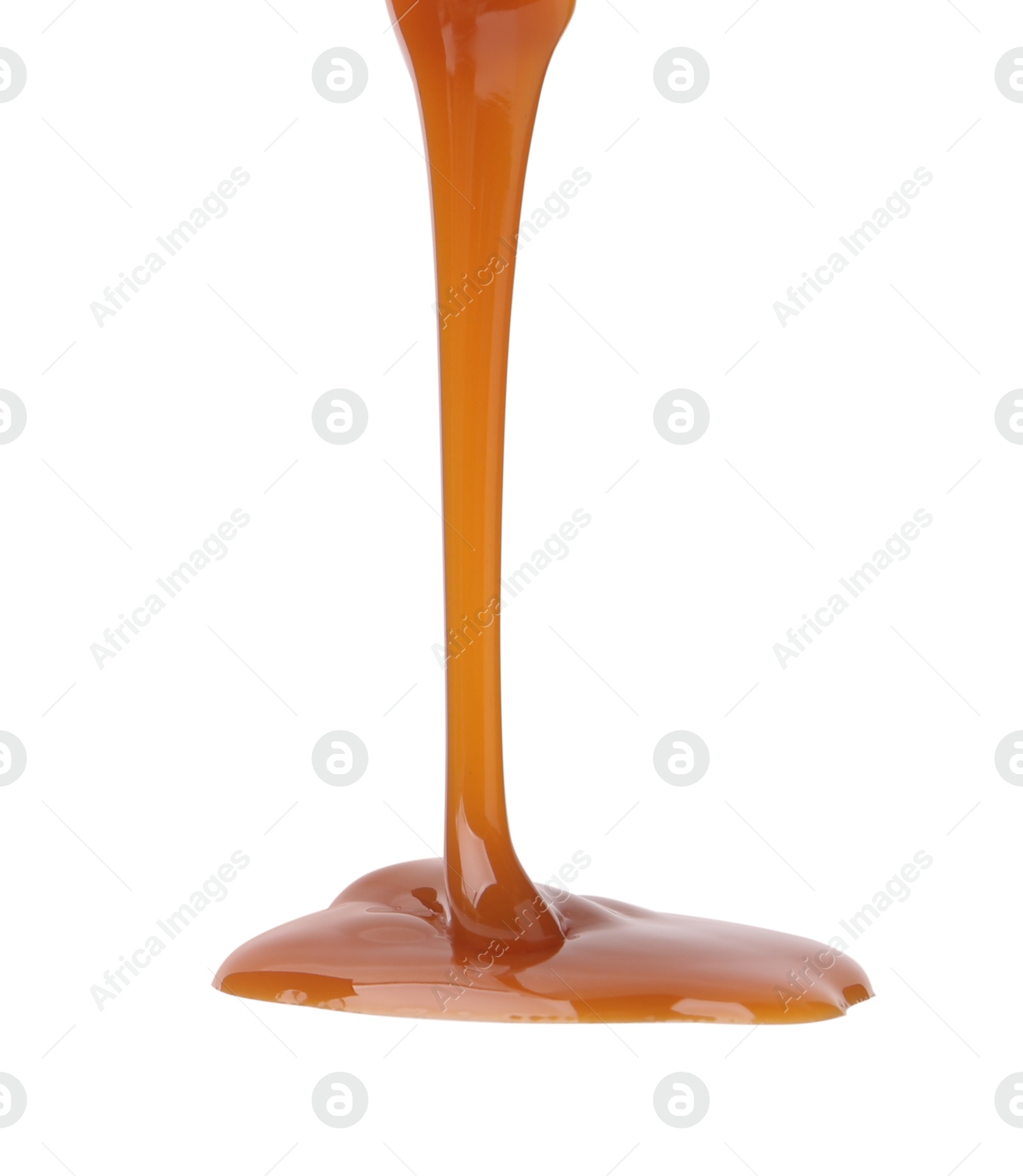 Photo of Tasty caramel sauce dripping from gravy boat on white background, closeup