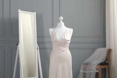 Photo of Beautiful wedding dress on mannequin in boutique