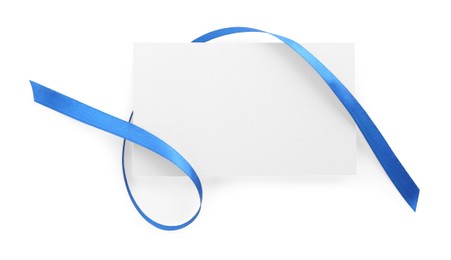 Photo of Blank card and blue ribbon isolated on white, top view