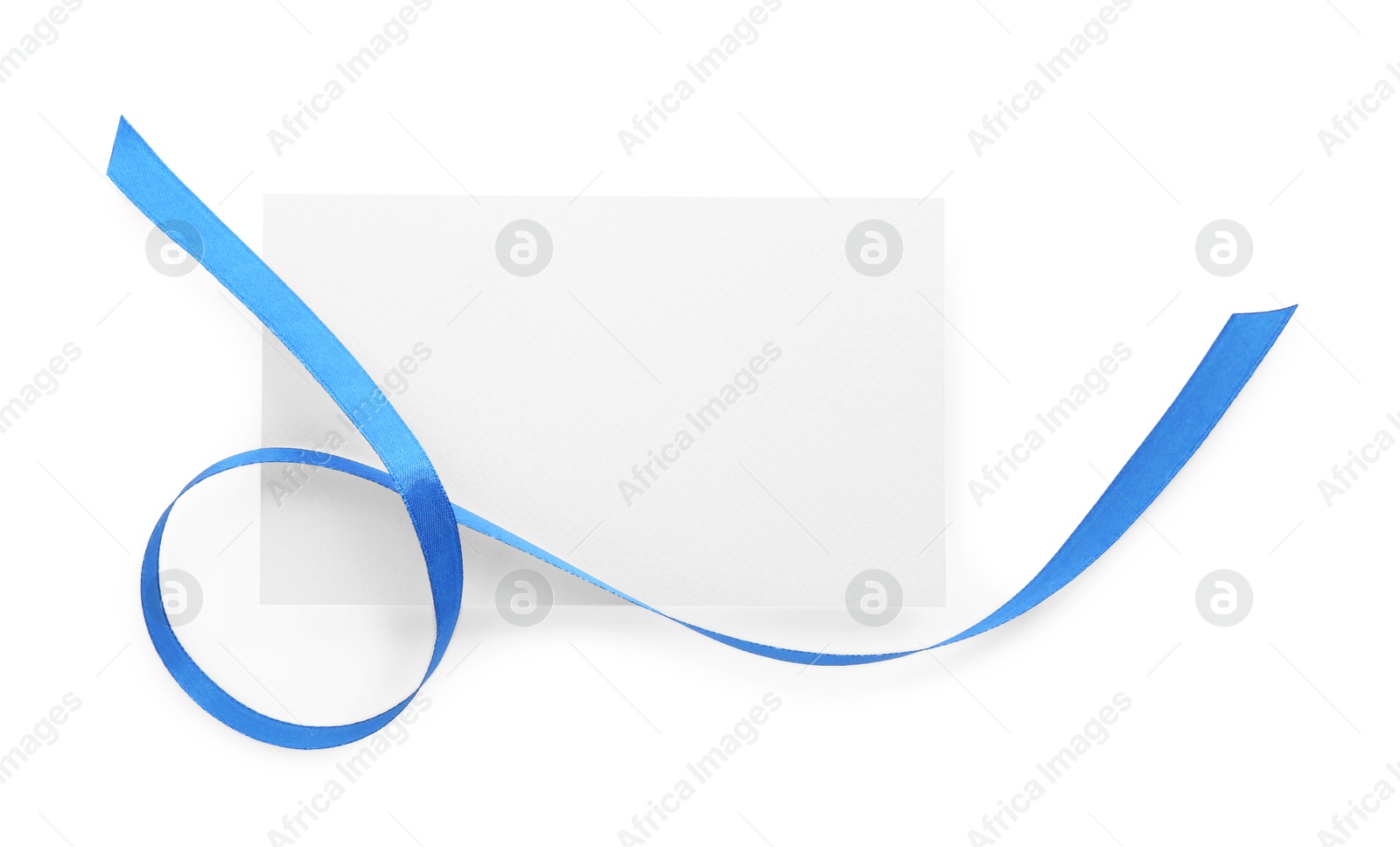 Photo of Blank card and blue ribbon isolated on white, top view