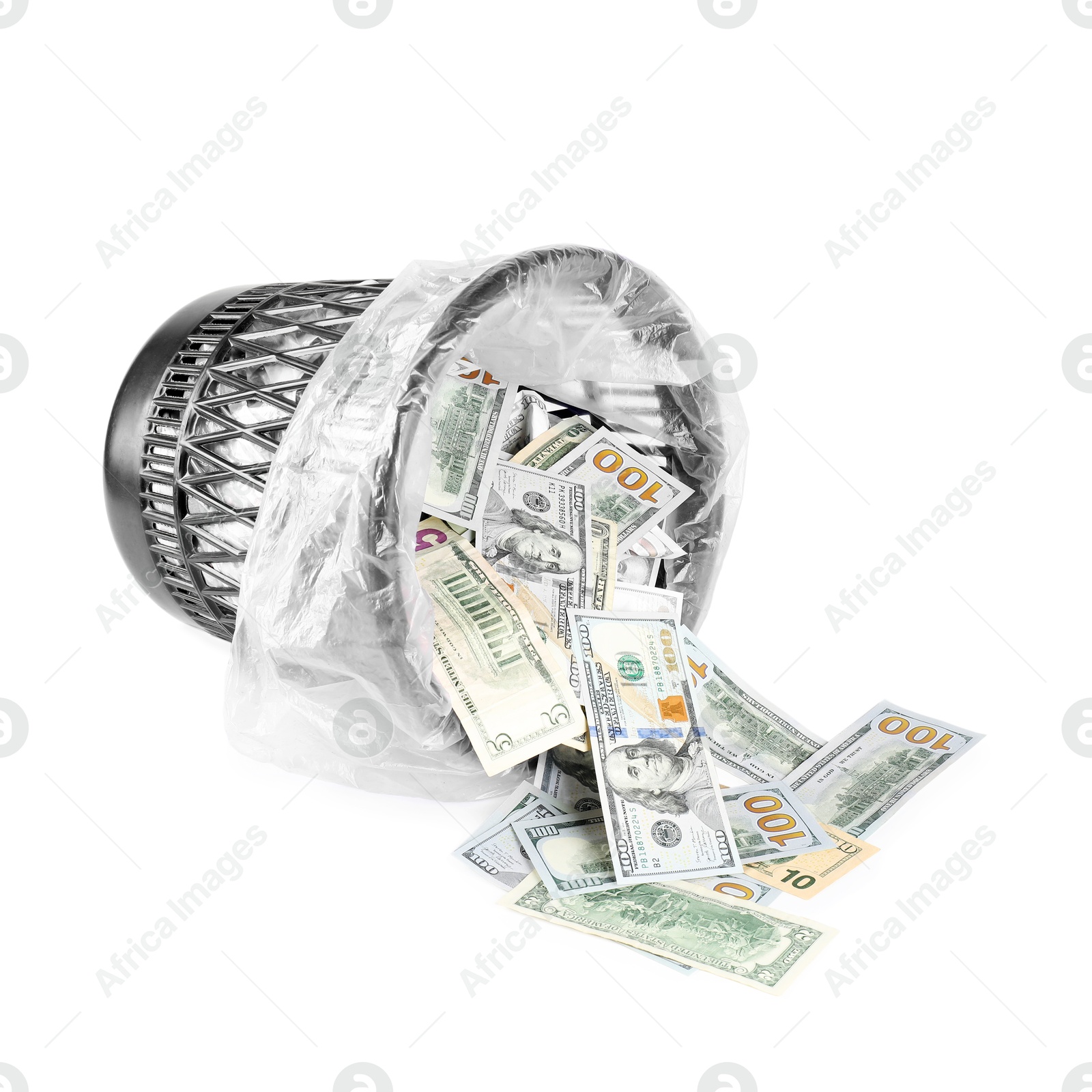Photo of Many dollar banknotes and overturned trash bin isolated on white