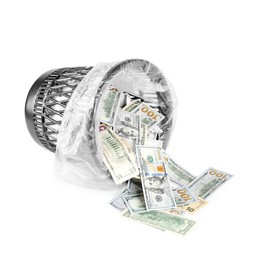 Photo of Many dollar banknotes and overturned trash bin isolated on white