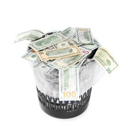 Photo of Many dollar banknotes in trash bin isolated on white