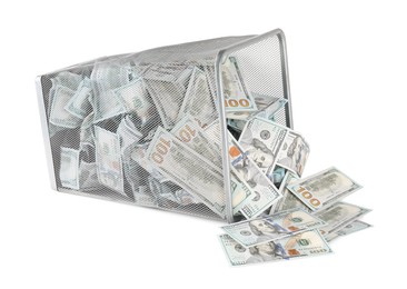 Photo of Many dollar banknotes and overturned trash bin isolated on white