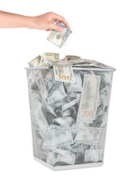 Photo of Woman throwing dollar banknote into trash bin on white background, closeup