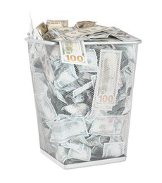 Photo of Many dollar banknotes in trash bin isolated on white