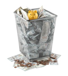 Photo of Many dollar banknotes and piggy bank in trash bin isolated on white