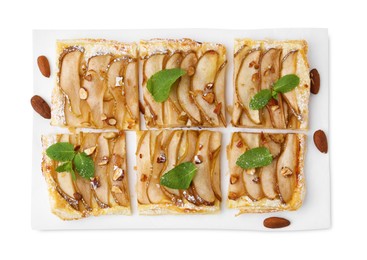 Photo of Pieces of tasty puff pastry pie with pears, mint and almonds isolated on white, top view