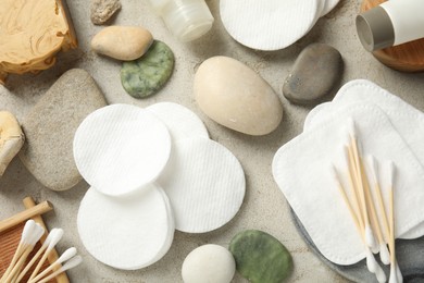 Photo of Flat lay composition with cotton pads and swabs on grey textured table