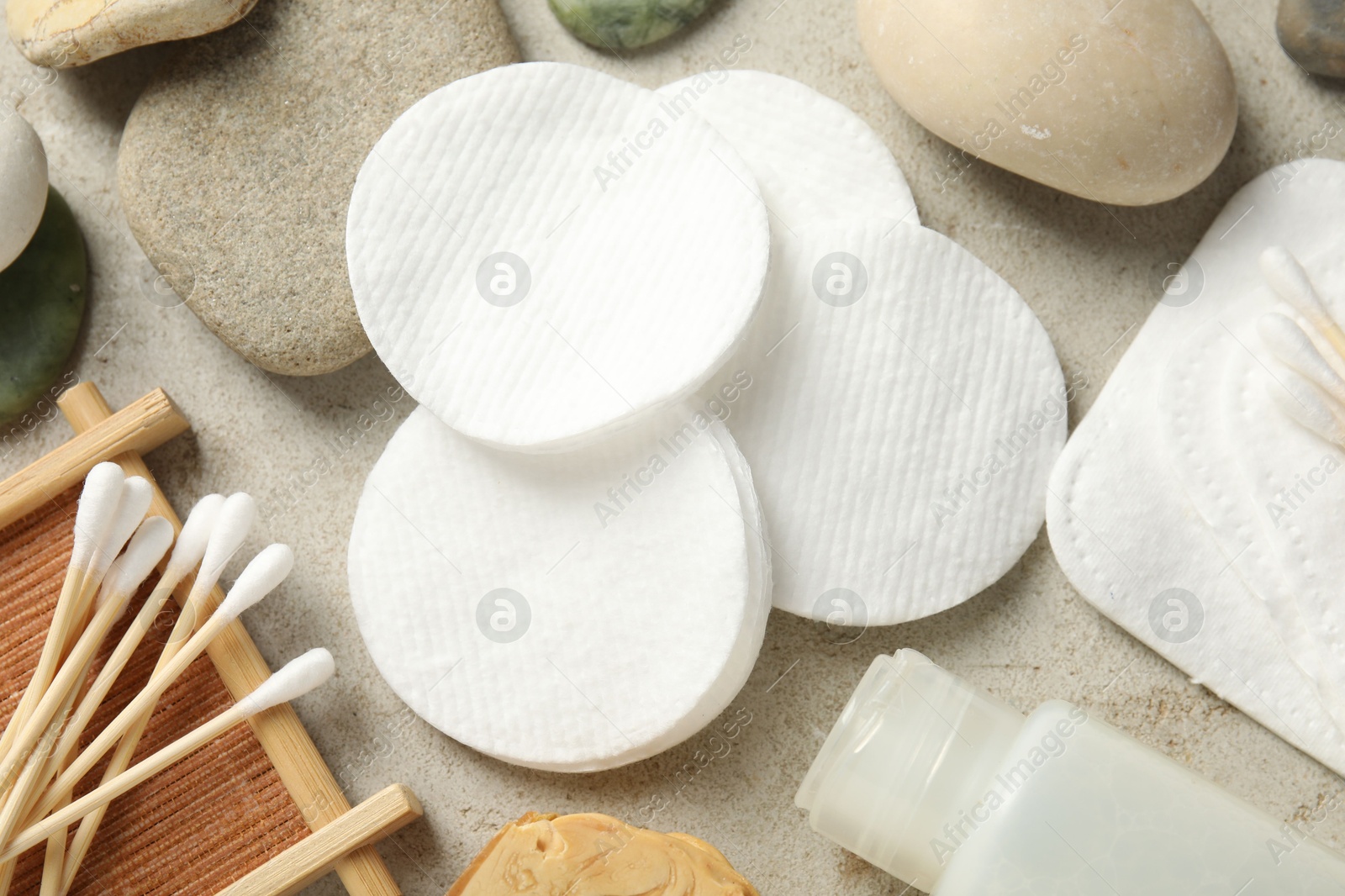 Photo of Flat lay composition with cotton pads and swabs on grey textured table