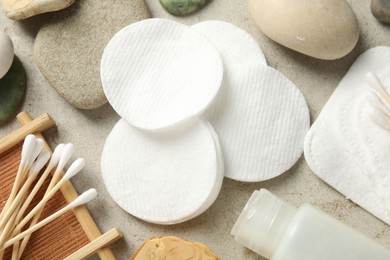 Photo of Flat lay composition with cotton pads and swabs on grey textured table