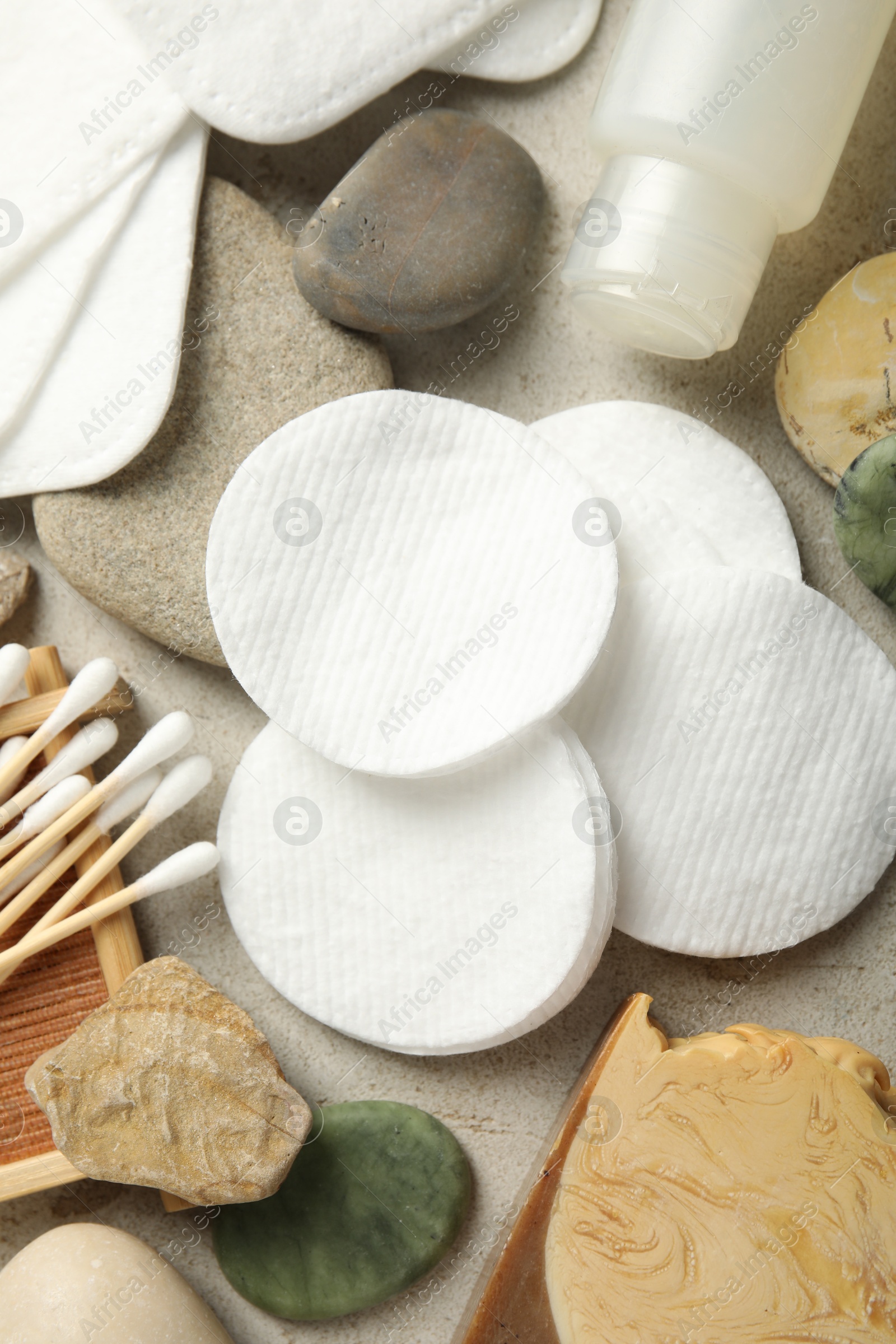 Photo of Flat lay composition with cotton pads and swabs on grey textured table